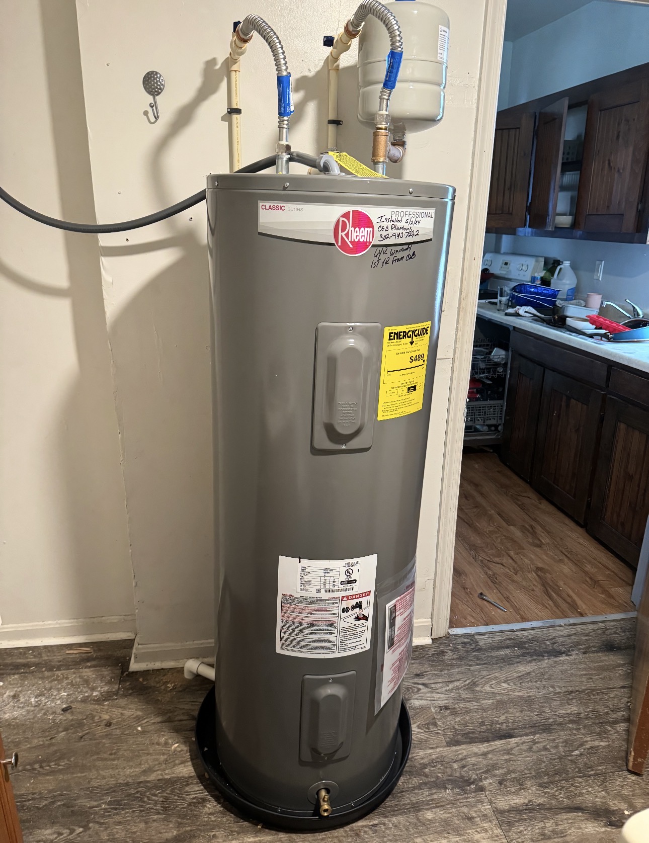 New Rheem electric water heater installed with expansion tank